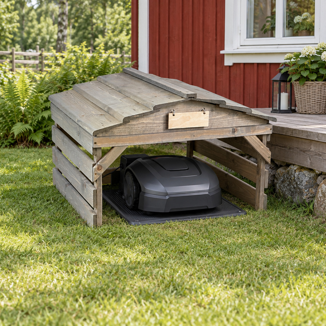 PLOKK 7047 robotic lawn mower garage, gray / gray, wood roof, beside a Nordic garden terrace with a robotic mower and charging base